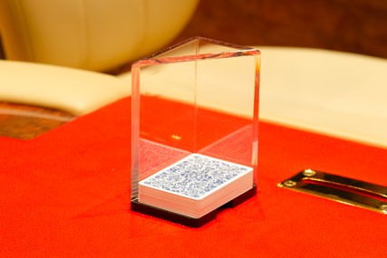 Discard played cards into a discard holder table accessory. Transparent model assists supervision of table events, improving operational security.