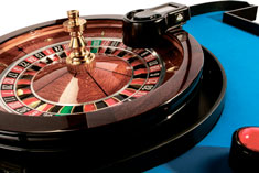 Give players control to launch roulette ball. Dealer loads roulette ball into device and a player presses a button on a wireless remote to launch the ball into the wheel.